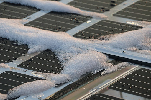 Snow accumulating on solar panels