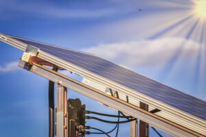 Sun rays hitting a ground mounted solar panel