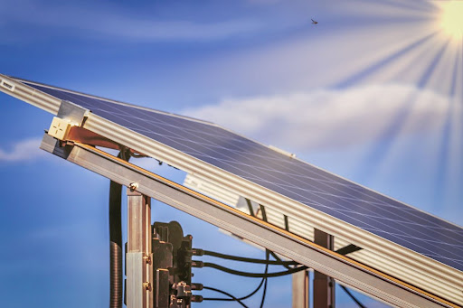 Sun rays hitting a ground mounted solar panel