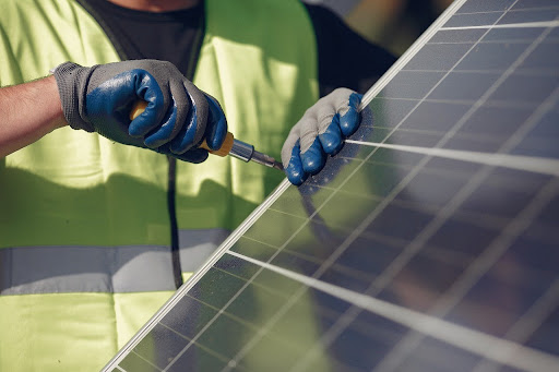 Technician installing a ground-mount solar panel